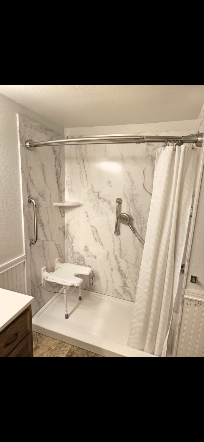 Finished FlexStone walk-in shower with folding seat